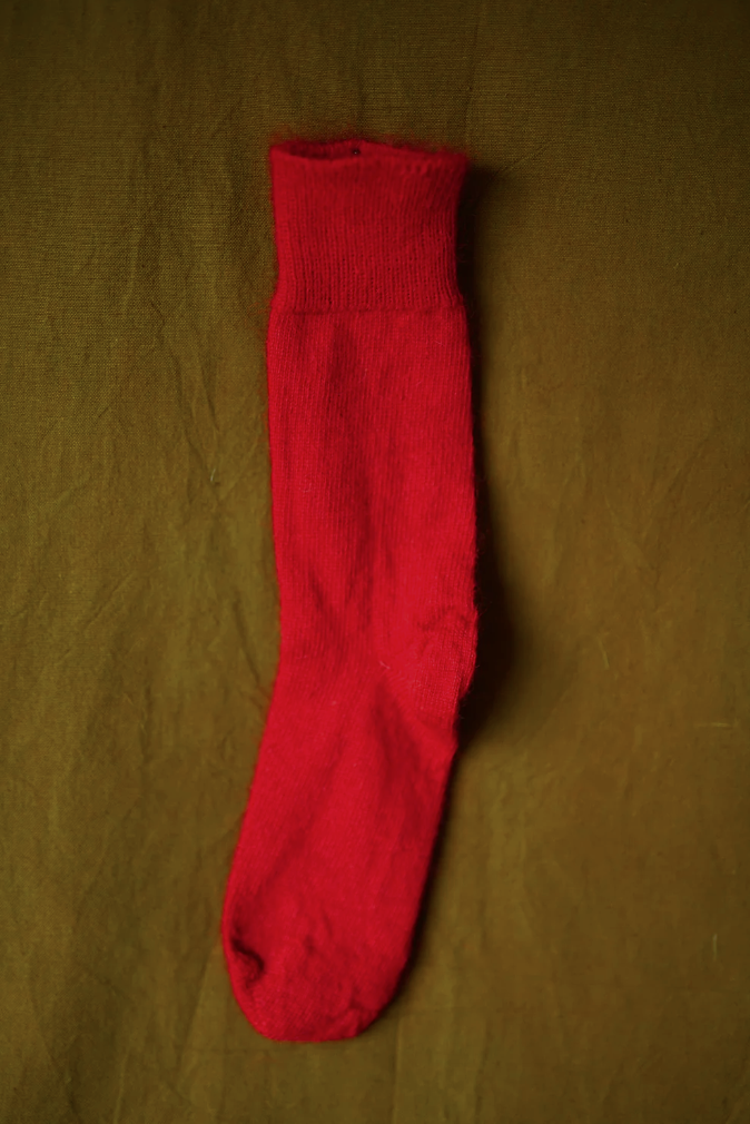 Women’s mohair calf length socks in red, shown laid flat, designed to wear with leather boots for warmth and comfort.