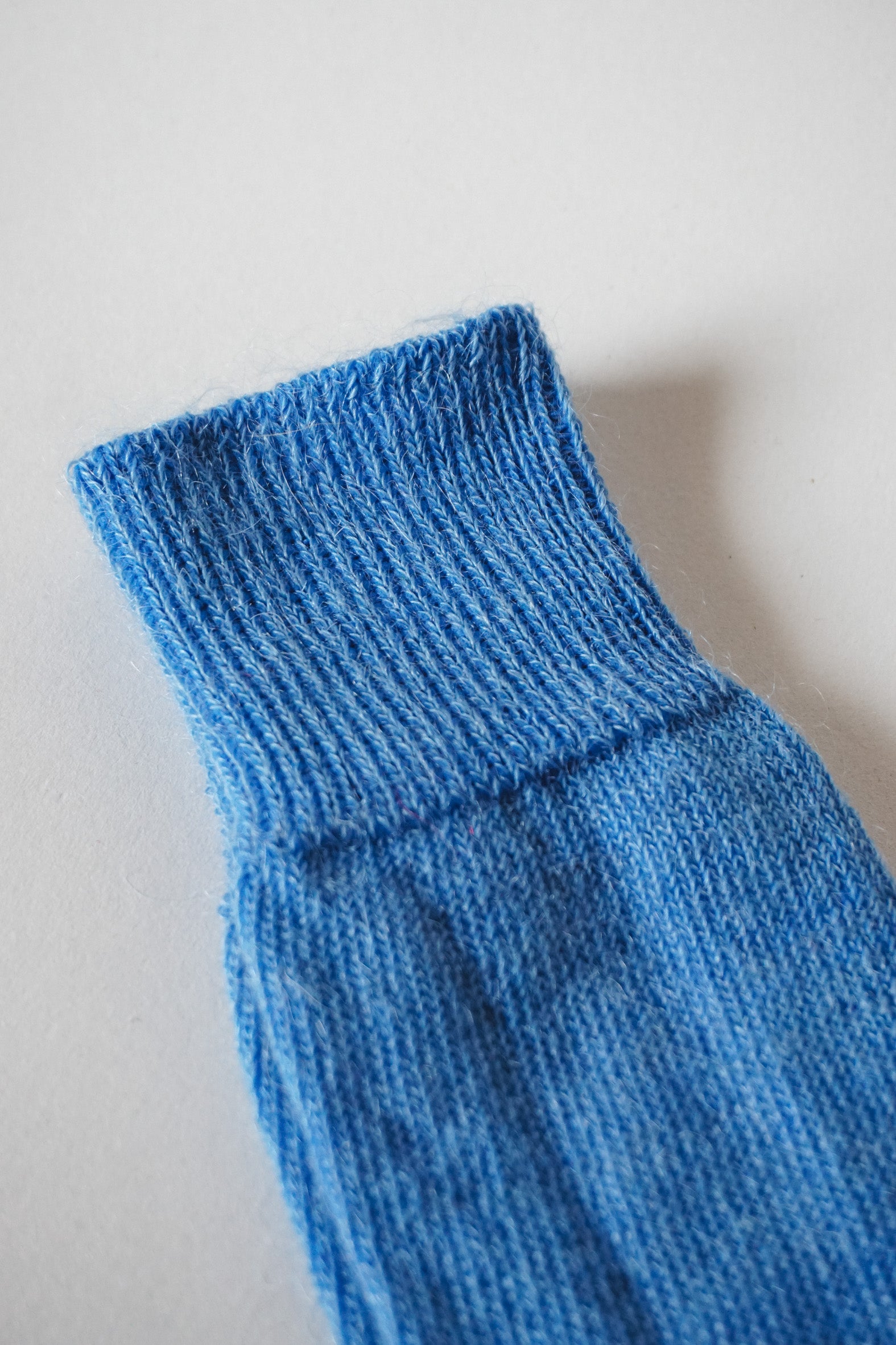 Women’s mohair calf length socks in cobalt blue close up view with ribbed cuff and soft knit texture for comfort when worn with leather boots. 