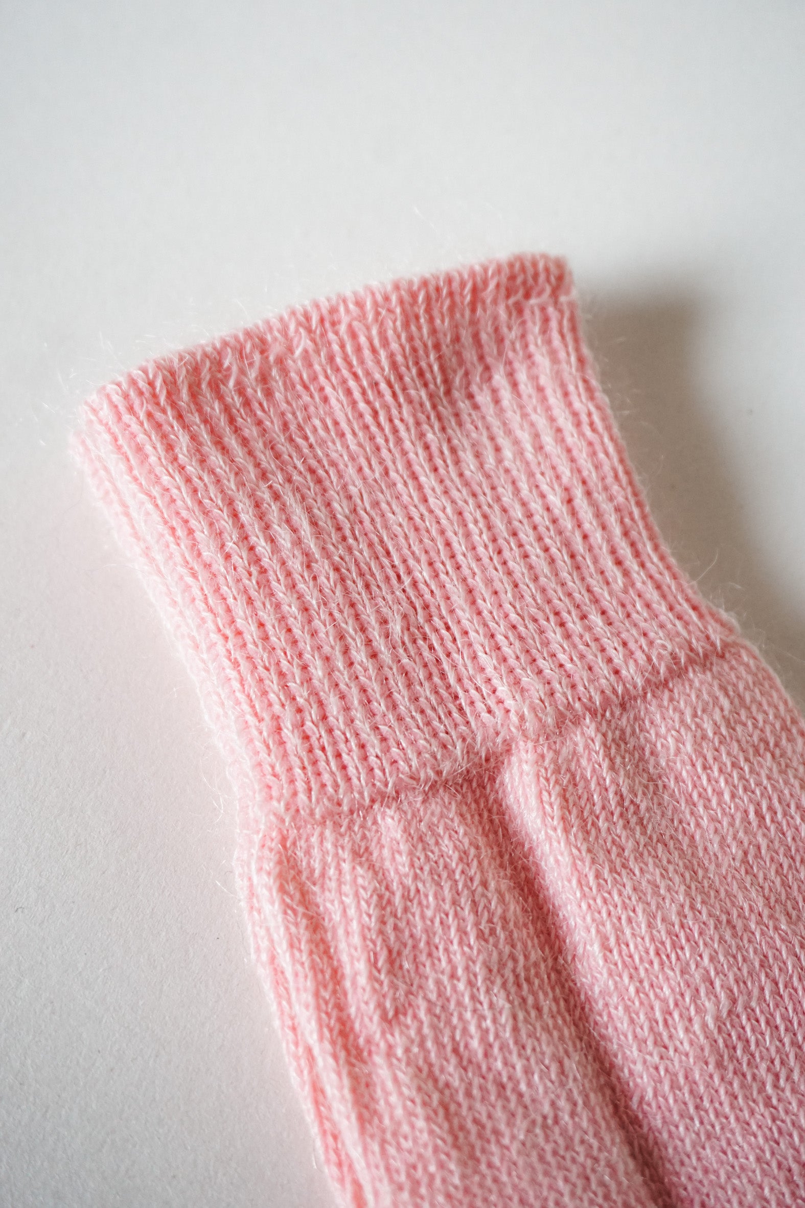 Women’s mohair calf length socks close up view with ribbed cuff and soft knit texture for comfort when worn with leather boots. 