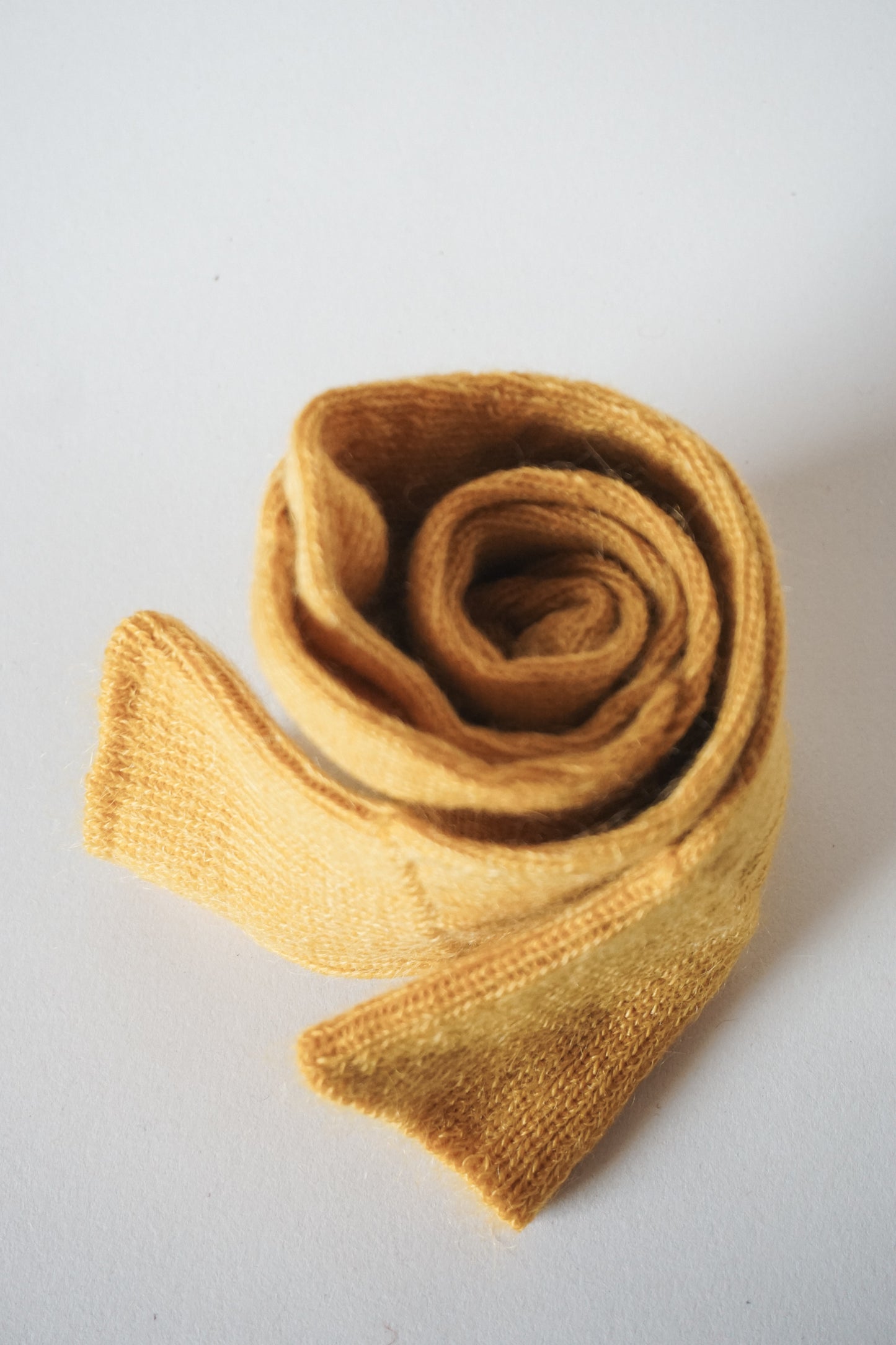 Women’s mohair calf length socks with ribbed cuff and soft knit texture for comfort when worn with leather boots. View of socks rolled up.