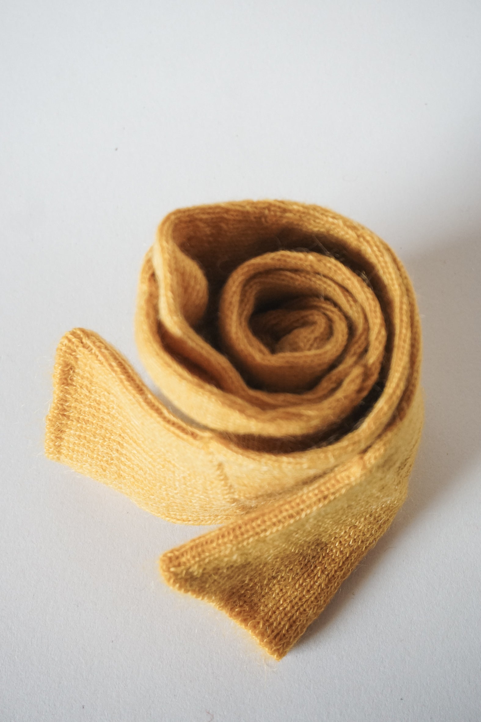 Women’s mohair calf length socks with ribbed cuff and soft knit texture for comfort when worn with leather boots. View of socks rolled up.