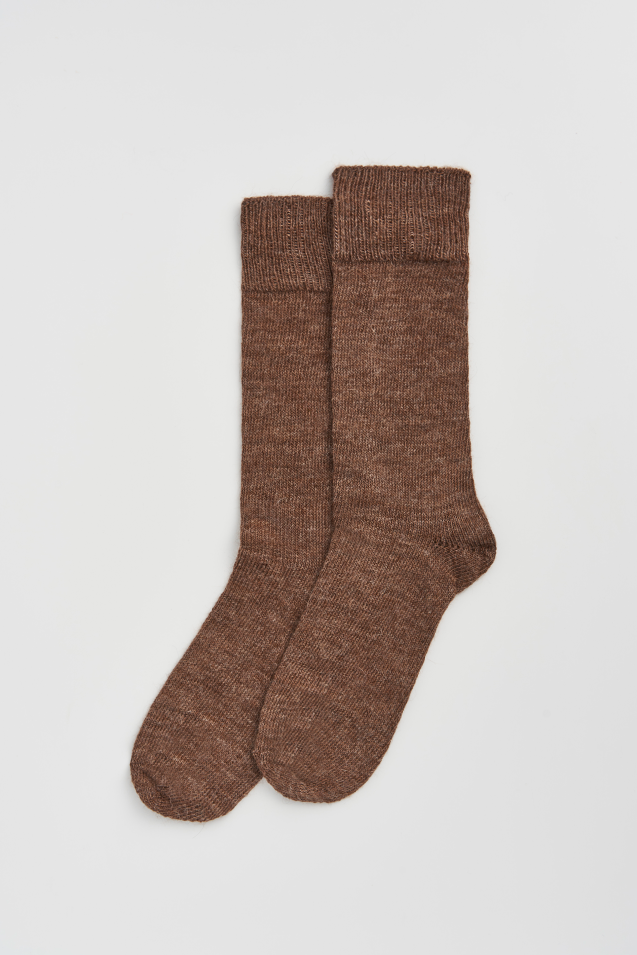 Women’s alpaca calf length socks in treacle brown, shown as a pair laid flat, designed to wear with leather boots for warmth and comfort.