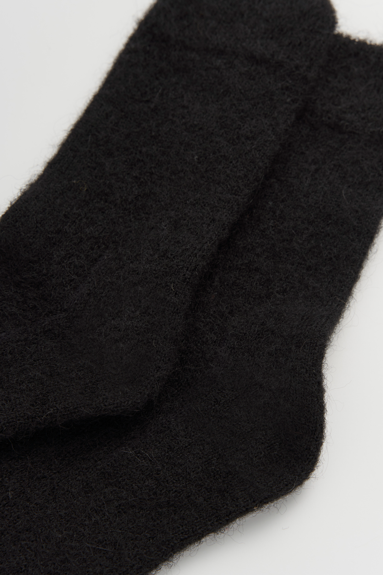 Women’s ultra soft alpaca calf length socks with super soft knit texture, close-up view for comfort when worn with leather boots.