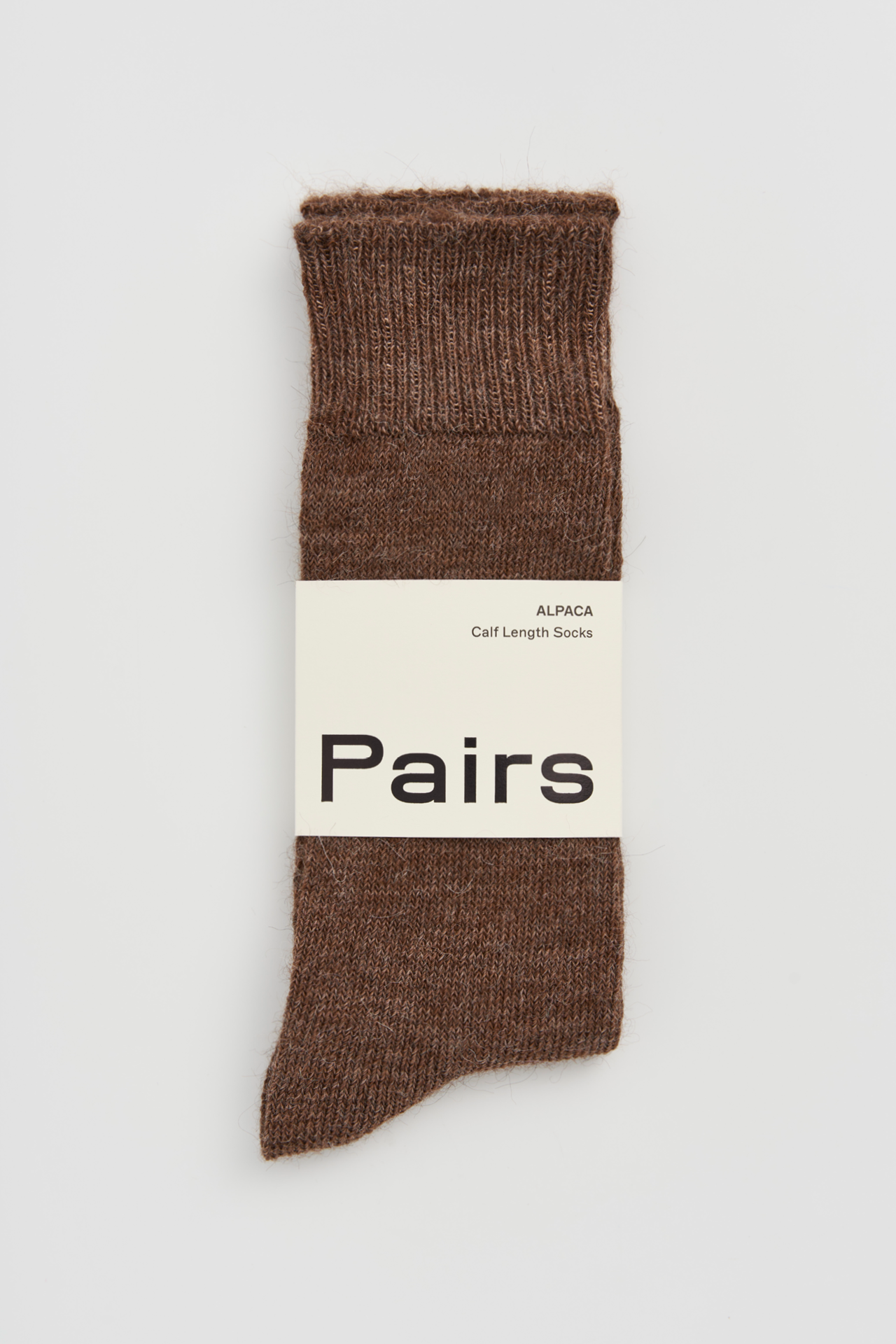 Women’s alpaca calf length socks in treacle brown with Pairs packaging, ideal for wearing with smart casual leather boots.